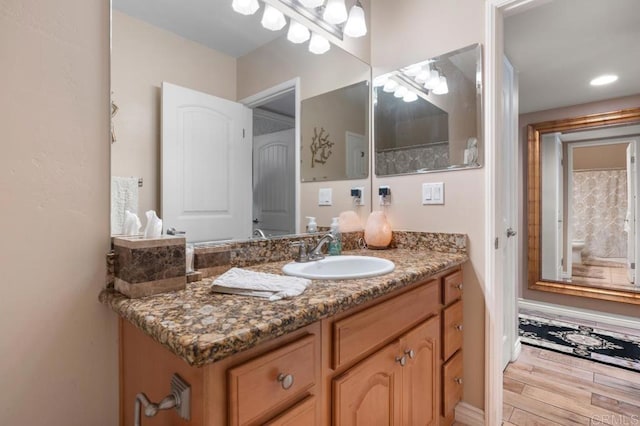 bathroom with vanity and wood finished floors