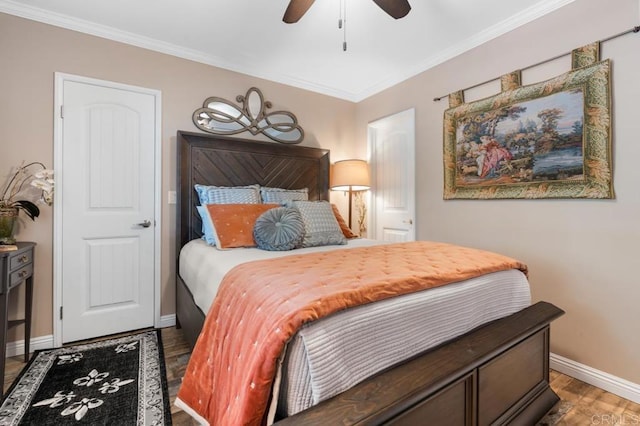 bedroom with baseboards, a ceiling fan, crown molding, and wood finished floors