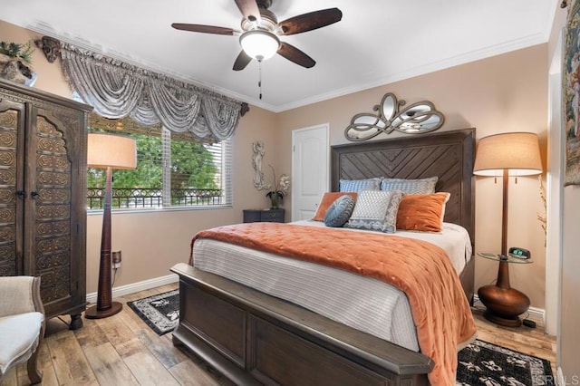 bedroom with baseboards, ornamental molding, ceiling fan, and light wood finished floors