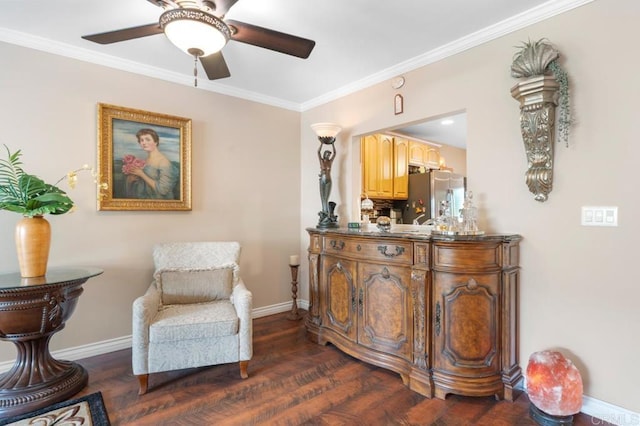 living area with baseboards, ornamental molding, dark wood finished floors, and ceiling fan