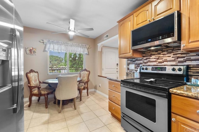 kitchen featuring appliances with stainless steel finishes, stone countertops, a ceiling fan, tasteful backsplash, and visible vents