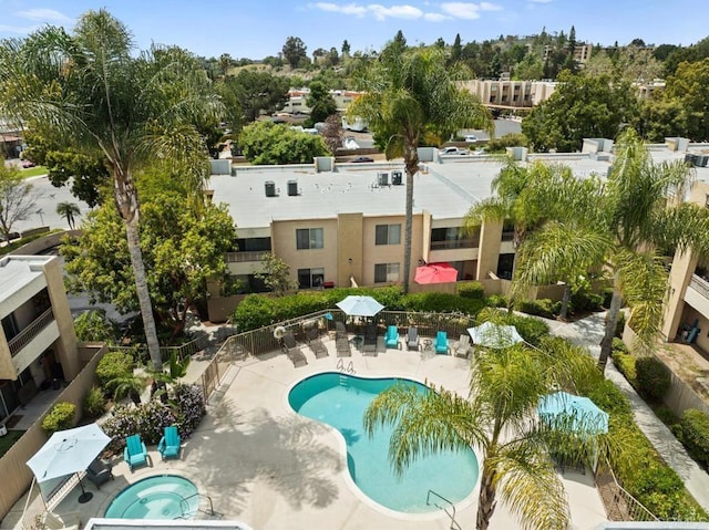pool featuring a hot tub, fence, and a patio area