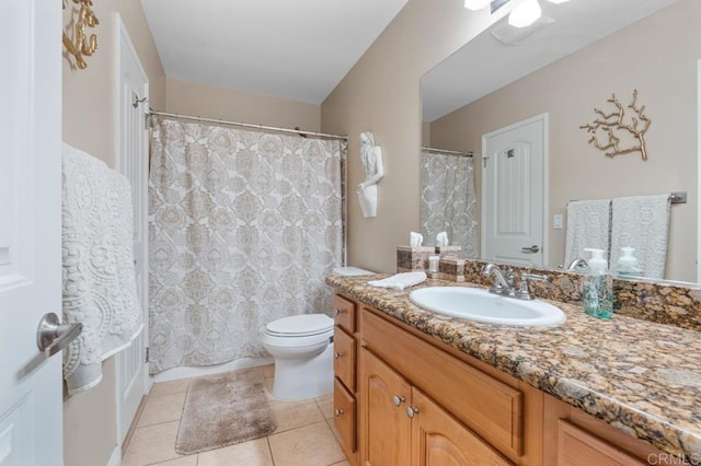 bathroom with toilet, tile patterned floors, curtained shower, and vanity