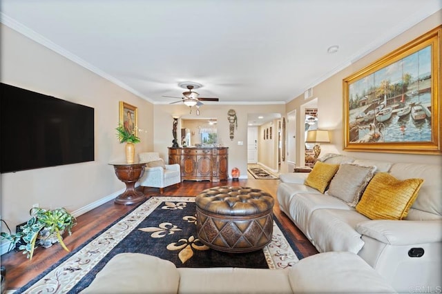 living room with baseboards, ornamental molding, ceiling fan, and wood finished floors