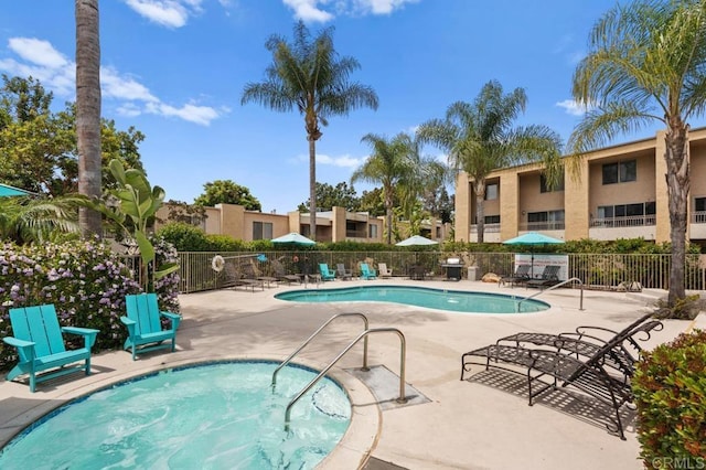 pool with fence and a patio