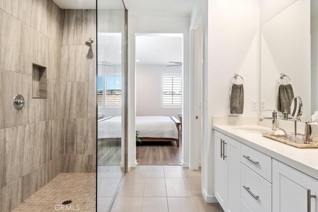 bathroom with vanity, tile patterned floors, walk in shower, and ensuite bath
