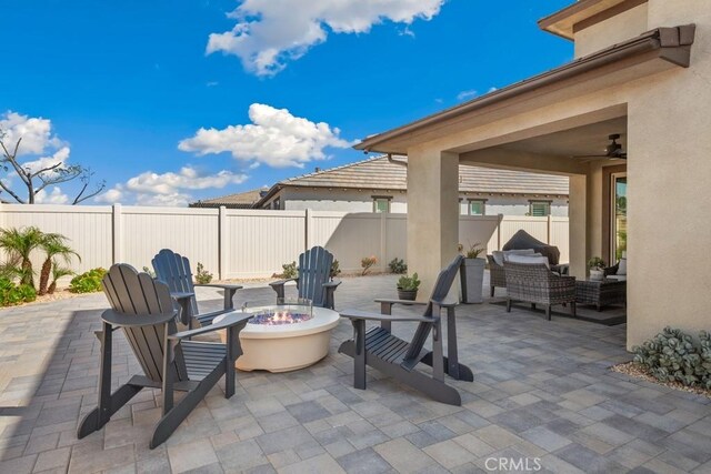view of patio / terrace featuring a fenced backyard and an outdoor living space with a fire pit