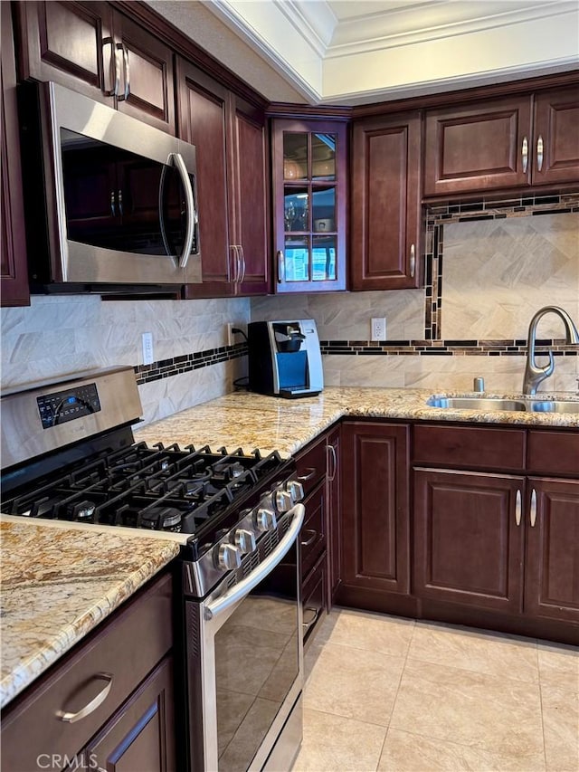 24612 Harbor View Dr Unit 55C, Dana Point, CA 92629 - kitchen with stainless steel appliances, ornamental molding, a sink, tasteful backsplash, and light stone countertops
