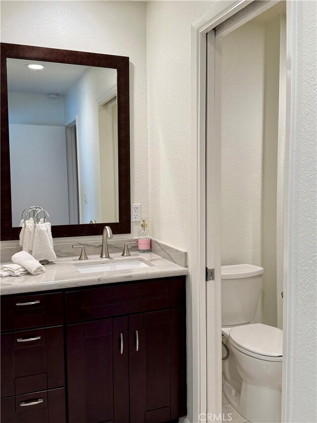 24612 Harbor View Dr Unit 55C, Dana Point, CA 92629 - bathroom featuring vanity, toilet, and a textured wall