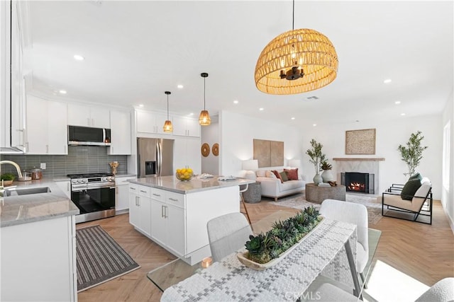kitchen featuring stainless steel appliances, recessed lighting, and a sink