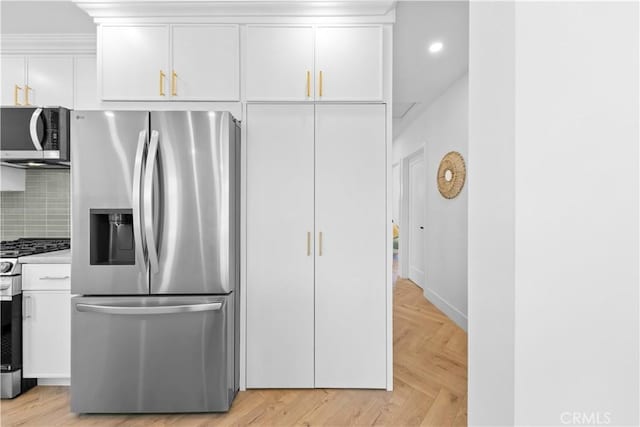 kitchen featuring decorative backsplash, appliances with stainless steel finishes, light countertops, white cabinets, and recessed lighting
