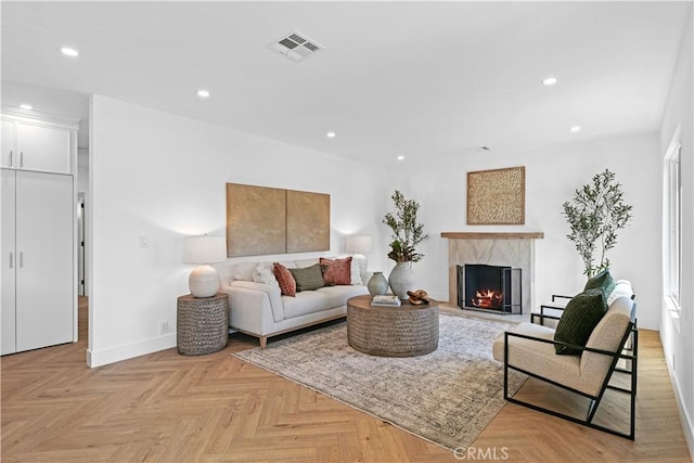living room with recessed lighting, baseboards, visible vents, and a fireplace