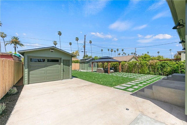 detached garage with fence and driveway