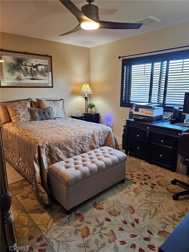 bedroom with carpet flooring, a ceiling fan, and visible vents
