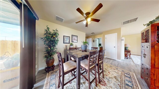 dining area featuring a ceiling fan, visible vents, and wood finished floors