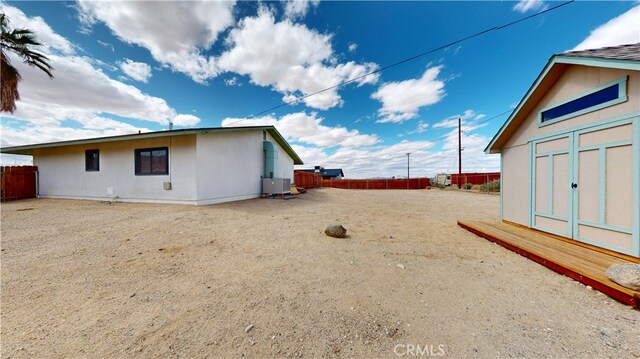 view of yard with fence and cooling unit
