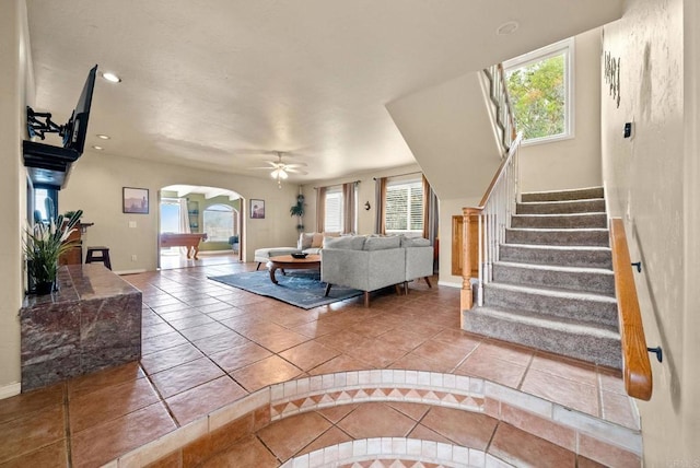 1994 Warmlands Ave, Vista, CA 92084 - tiled living area featuring healthy amount of natural light, arched walkways, baseboards, stairs, and recessed lighting