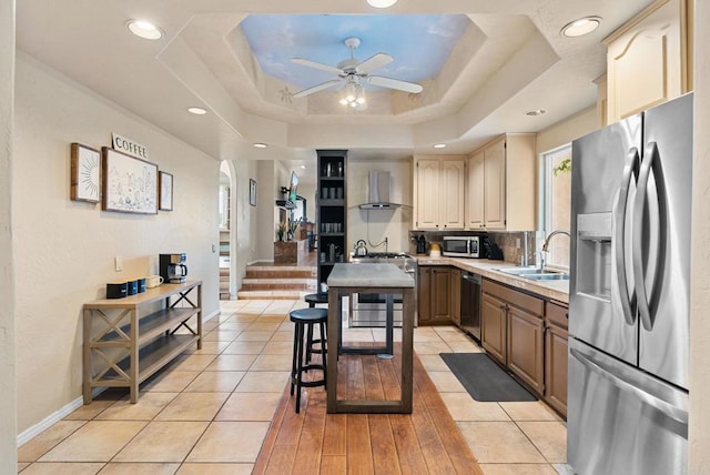 1994 Warmlands Ave, Vista, CA 92084 - kitchen with appliances with stainless steel finishes, a sink, wall chimney range hood, light countertops, and a ceiling fan