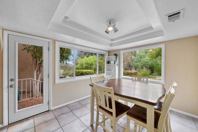 1994 Warmlands Ave, Vista, CA 92084 - dining space with baseboards, a tray ceiling, light tile patterned floors, and a textured ceiling