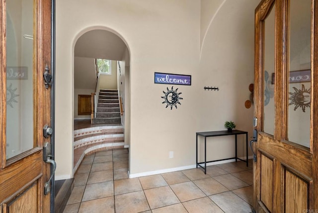 1994 Warmlands Ave, Vista, CA 92084 - foyer entrance with light tile patterned flooring, stairs, baseboards, and arched walkways