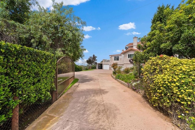 1994 Warmlands Ave, Vista, CA 92084 - view of concrete driveway featuring a gate and a gated entry
