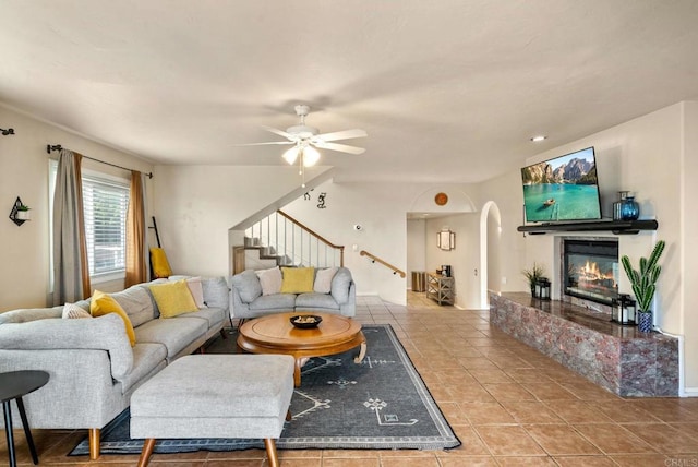 1994 Warmlands Ave, Vista, CA 92084 - tiled living room with stairs, ceiling fan, arched walkways, and a glass covered fireplace