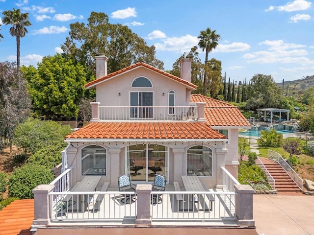 1994 Warmlands Ave, Vista, CA 92084 - rear view of house featuring a chimney, a tile roof, stucco siding, stairway, and a balcony