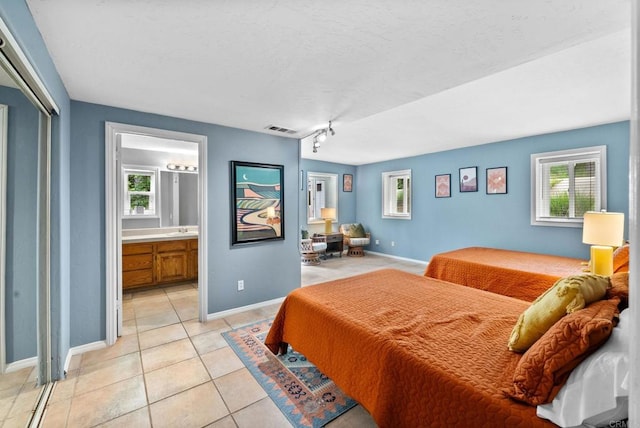 1994 Warmlands Ave, Vista, CA 92084 - bedroom featuring multiple windows, light tile patterned floors, baseboards, and a textured ceiling