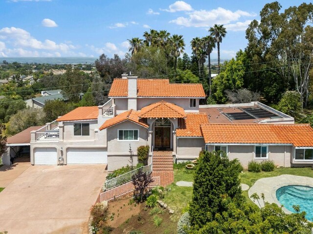 1994 Warmlands Ave, Vista, CA 92084 - mediterranean / spanish-style home with a tile roof, stucco siding, driveway, a balcony, and a chimney