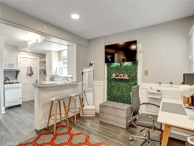 16855 12th St, Sunset Beach, CA 90742 - dining room featuring wainscoting, wood finished floors, and recessed lighting