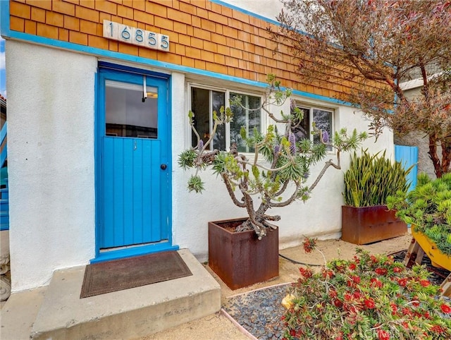 16855 12th St, Sunset Beach, CA 90742 - doorway to property featuring stucco siding