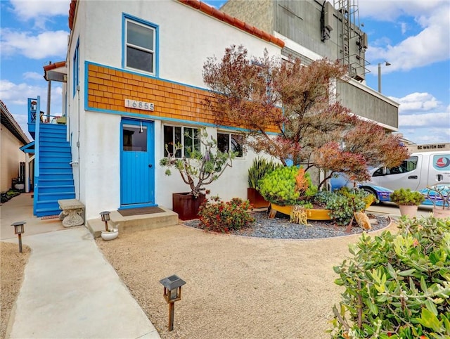 16855 12th St, Sunset Beach, CA 90742 - mediterranean / spanish home with stucco siding and stairs