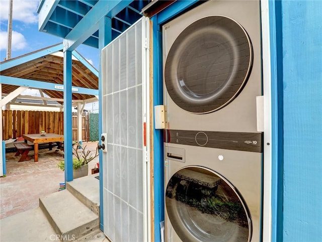 16855 12th St, Sunset Beach, CA 90742 - laundry area with stacked washer and clothes dryer and brick patterned floors