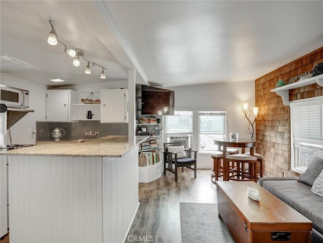 16855 12th St, Sunset Beach, CA 90742 - kitchen featuring open shelves, white cabinets, light wood finished floors, white microwave, and stovetop