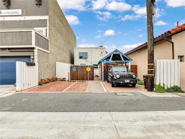 16855 12th St, Sunset Beach, CA 90742 - view of building exterior featuring uncovered parking and fence