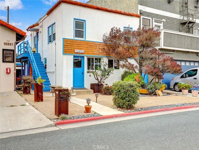 16855 12th St, Sunset Beach, CA 90742 - view of front of property with stairs and stucco siding