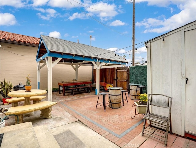 16855 12th St, Sunset Beach, CA 90742 - view of patio / terrace with outdoor dining area, a gazebo, a gate, and fence