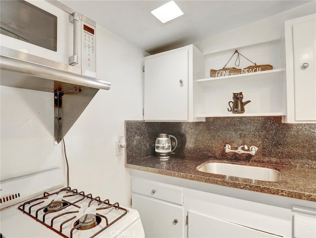 16855 12th St, Sunset Beach, CA 90742 - kitchen featuring a sink, open shelves, white gas range oven, tasteful backsplash, and white cabinets