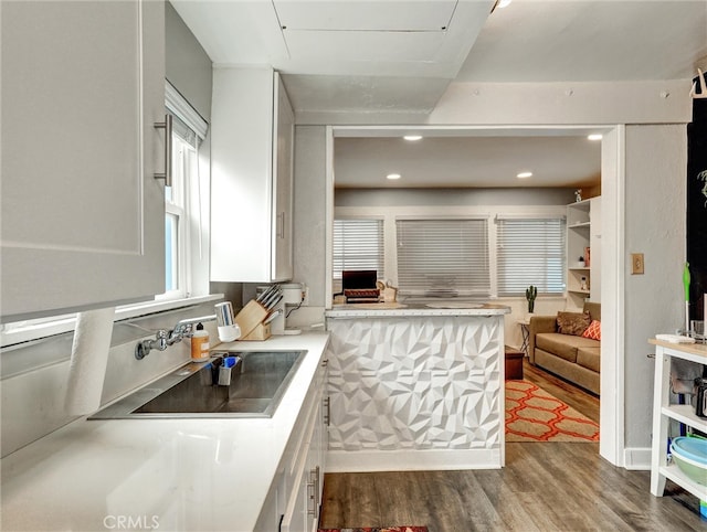 16855 12th St, Sunset Beach, CA 90742 - kitchen featuring a sink, dark wood finished floors, white cabinets, light countertops, and open floor plan