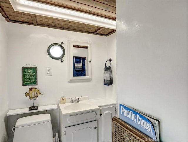 16855 12th St, Sunset Beach, CA 90742 - half bathroom with toilet, vanity, and wood ceiling