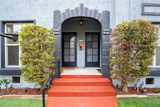 property entrance with stucco siding