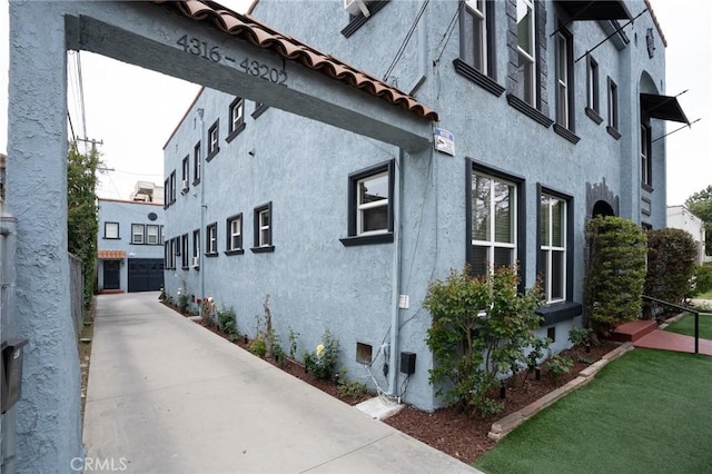 view of side of home with stucco siding
