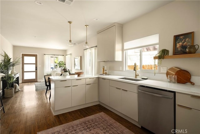 3420 Lifur Ave, Los Angeles, CA 90032 - kitchen with stainless steel dishwasher, a sink, a peninsula, dark wood-style flooring, and light countertops