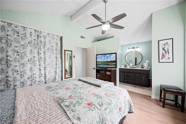 875 S Rexford St, Rialto, CA 92376 - bedroom with light wood finished floors, a textured ceiling, baseboards, connected bathroom, and a ceiling fan