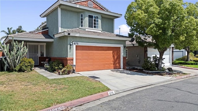 875 S Rexford St, Rialto, CA 92376 - traditional home with a garage, stucco siding, brick siding, a front yard, and driveway
