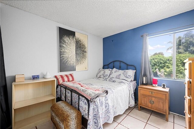 875 S Rexford St, Rialto, CA 92376 - bedroom featuring light tile patterned flooring and a textured ceiling