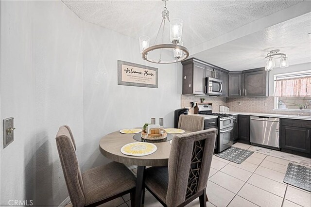 875 S Rexford St, Rialto, CA 92376 - dining area with a chandelier, light tile patterned flooring, and a textured ceiling