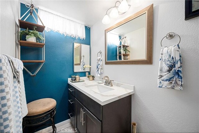 875 S Rexford St, Rialto, CA 92376 - bathroom featuring vanity, baseboards, and a textured wall