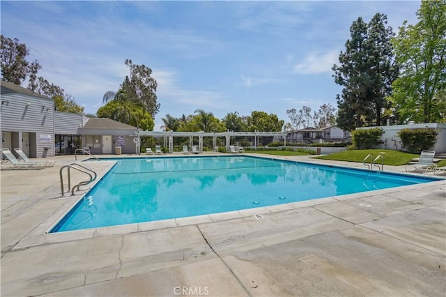 pool featuring a patio area and fence