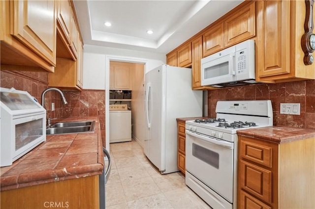 20332 Flower Gate Ln Unit 7, Yorba Linda, CA 92886 - kitchen with a sink, white appliances, washer / dryer, tile countertops, and decorative backsplash